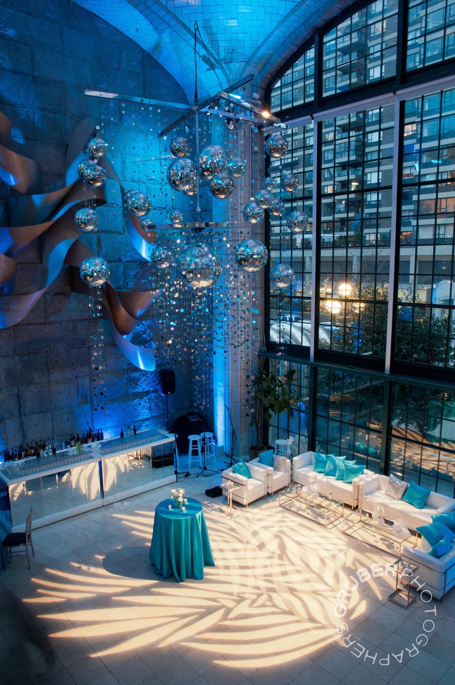 A large room with a lot of windows and tables and chairs.