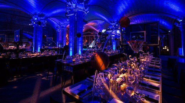 A room filled with tables and chairs and blue lights.