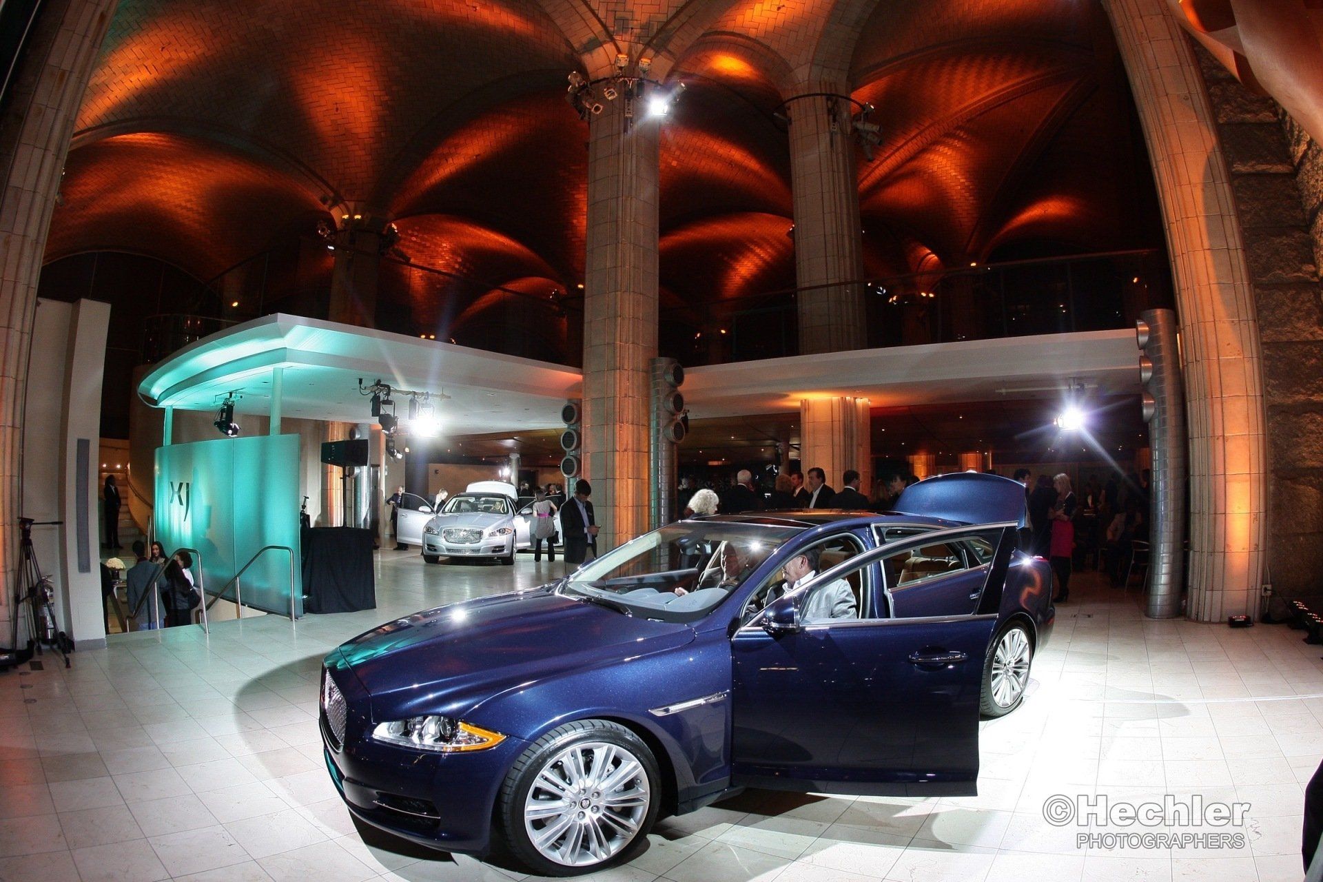 A blue car is parked in a large building
