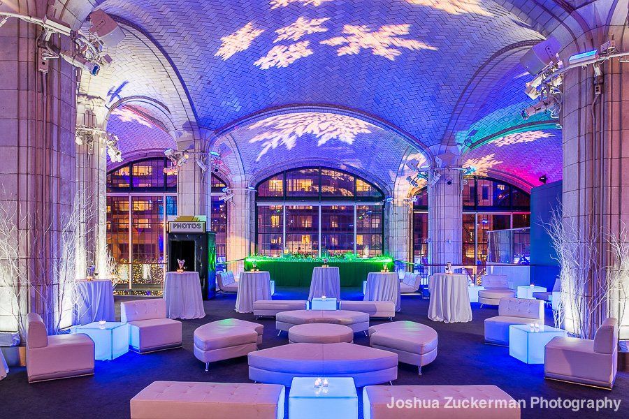 A large room with a blue ceiling and tables and chairs.