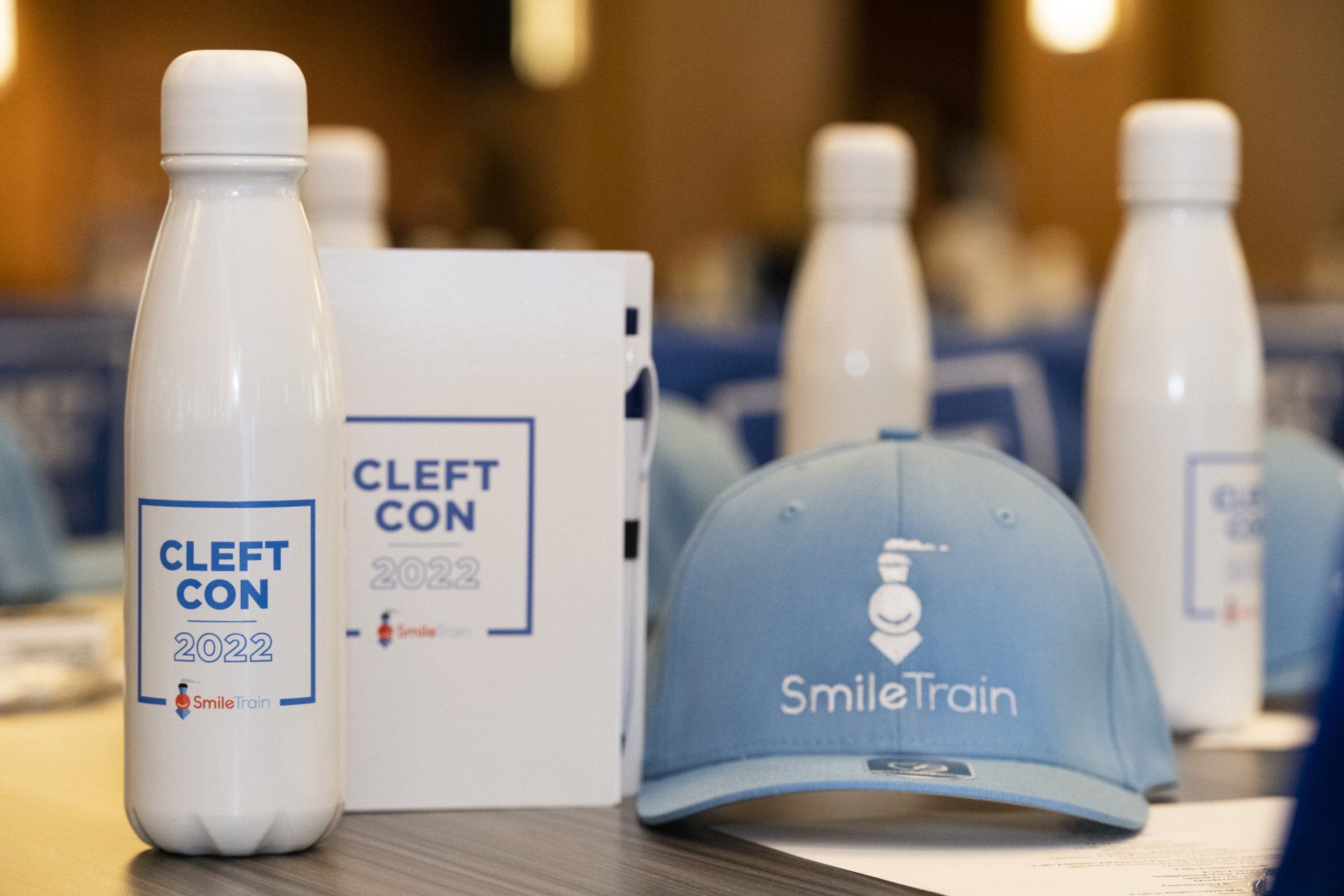 A bottle of water and a hat are on a table.