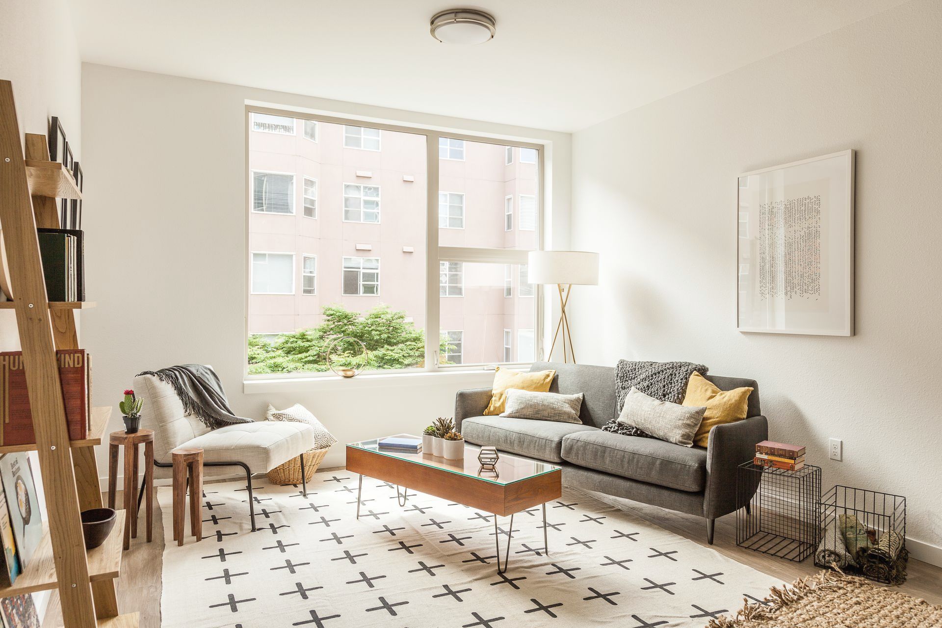 A living room with a couch , chair , coffee table and rug.