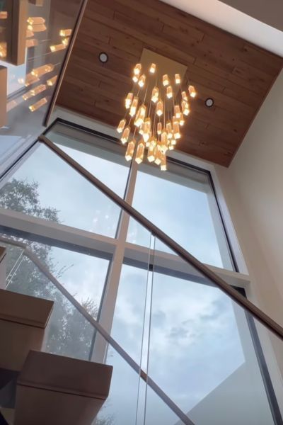 A staircase with a chandelier hanging from the ceiling