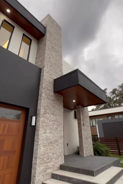 A modern house with a wooden door and stairs
