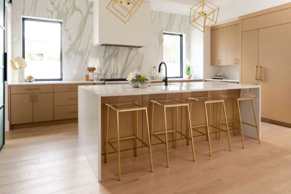 A kitchen with a large island and stools