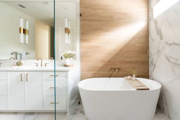 A bathroom with a bathtub , sink , mirror and walk in shower.