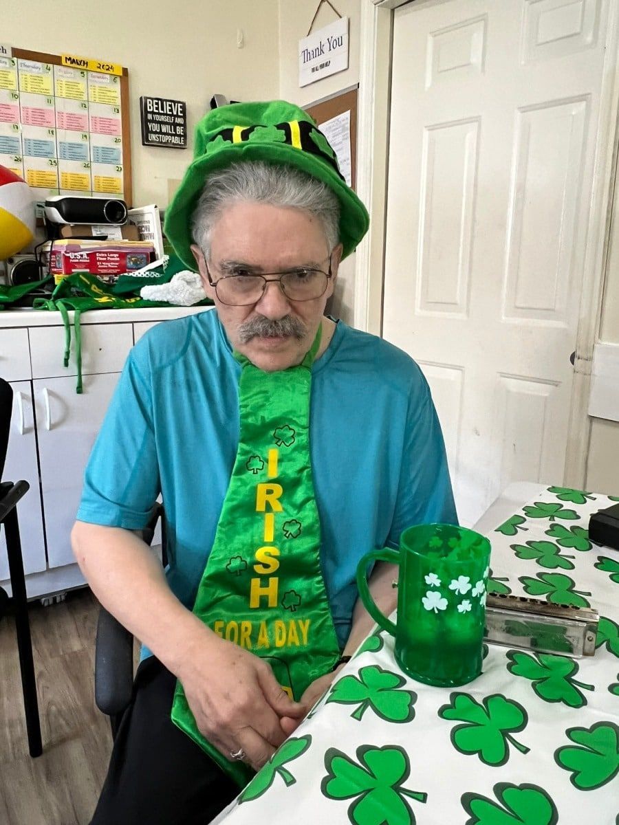 A person wearing a green shamrock hat and an 