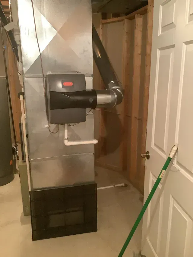 A room with a door and a mop in it