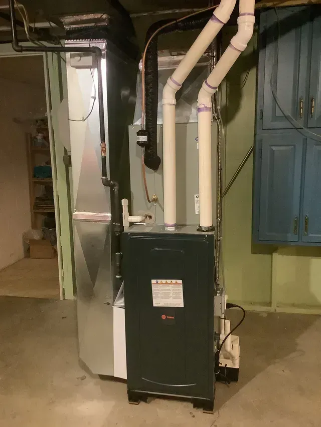 A heating and cooling system is installed in a basement.