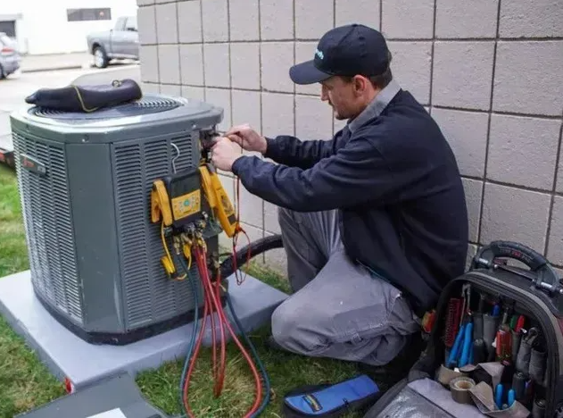 A technician repairing an air conditioning.