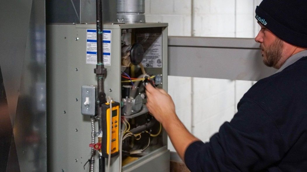 Repairman fixing a furnace