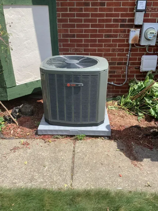 Air conditioning unit on a concrete base. Air conditioning unit on a concrete base.