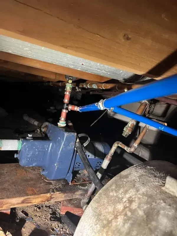 A close up of a pipe under a wooden ceiling.