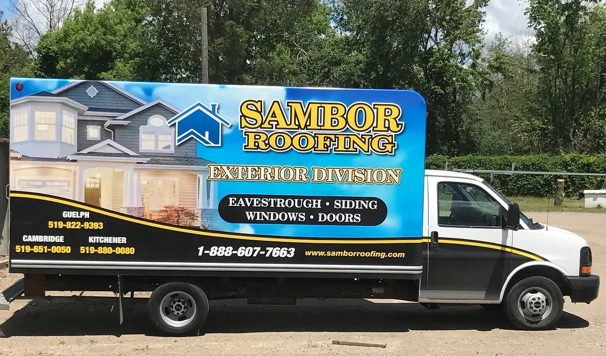 A white and blue van with that says sambor roofing