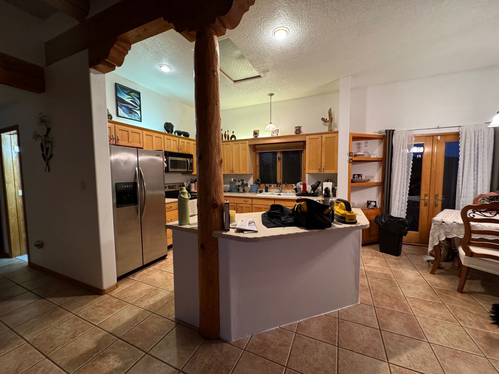 A kitchen with a large island and stainless steel appliances