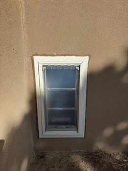A small window on the side of a building.