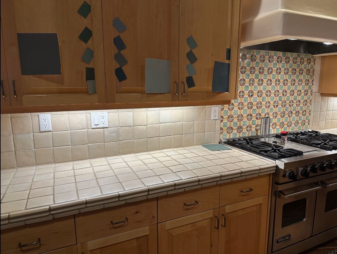 A kitchen with wooden cabinets and a stove top oven