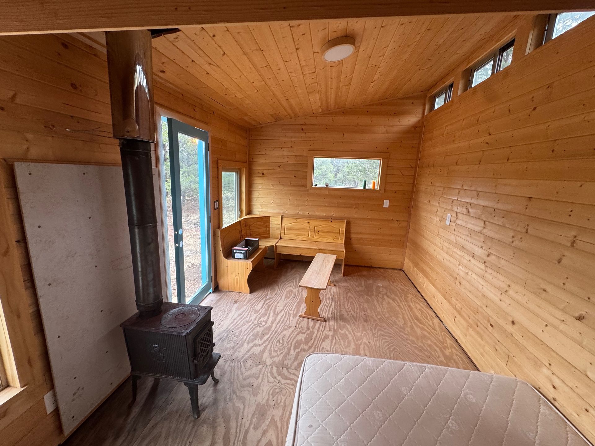 There is a wood stove in the middle of the room.