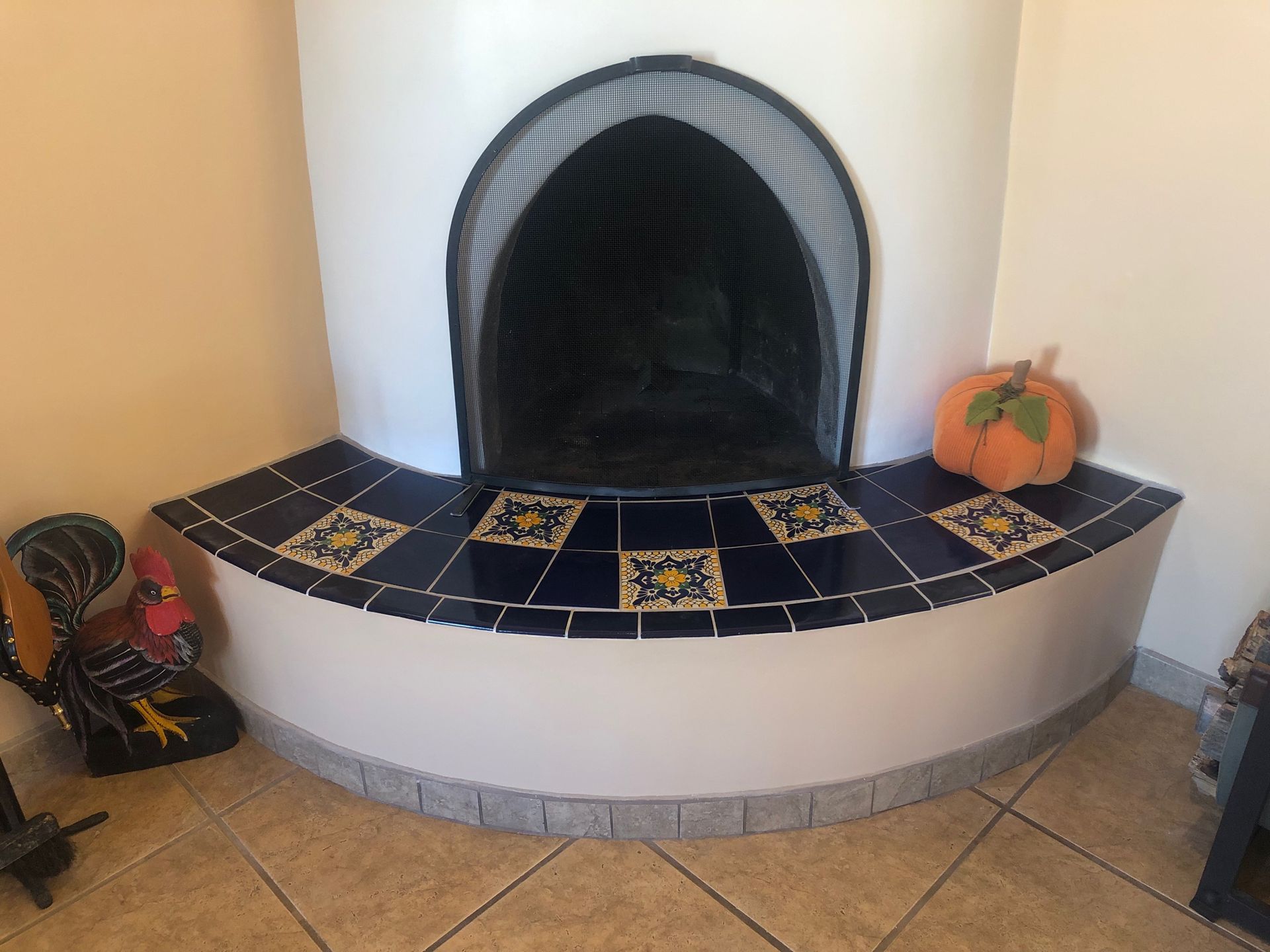 A fireplace with a pumpkin on the corner of it