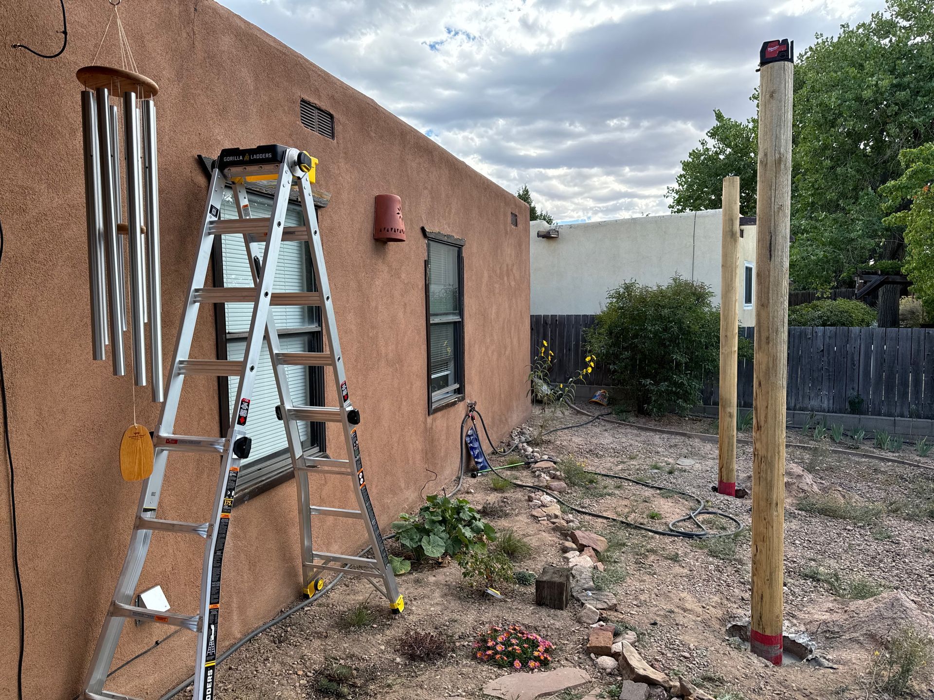 A ladder is sitting in front of a house.