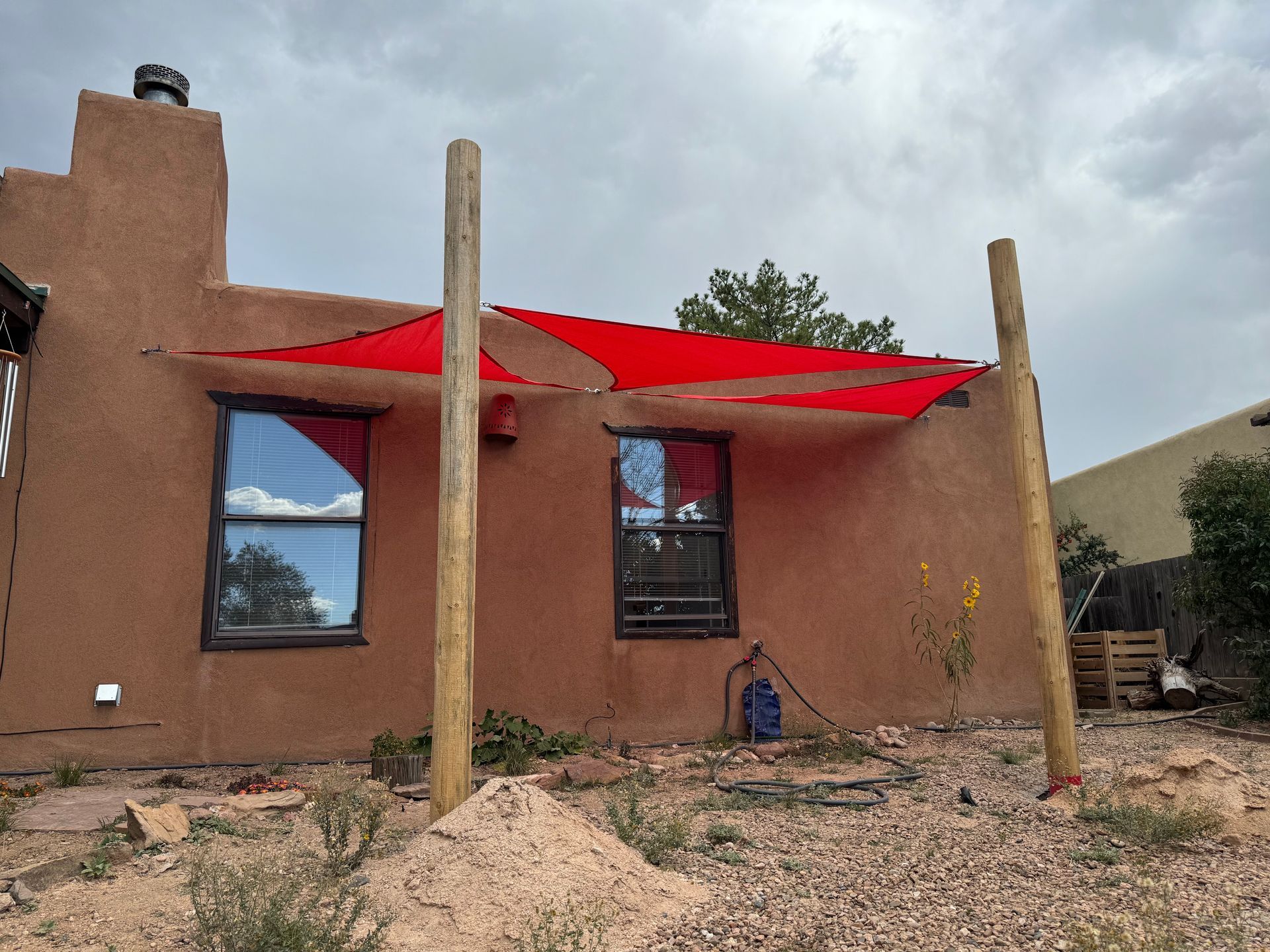 A house with a red umbrella on top of it