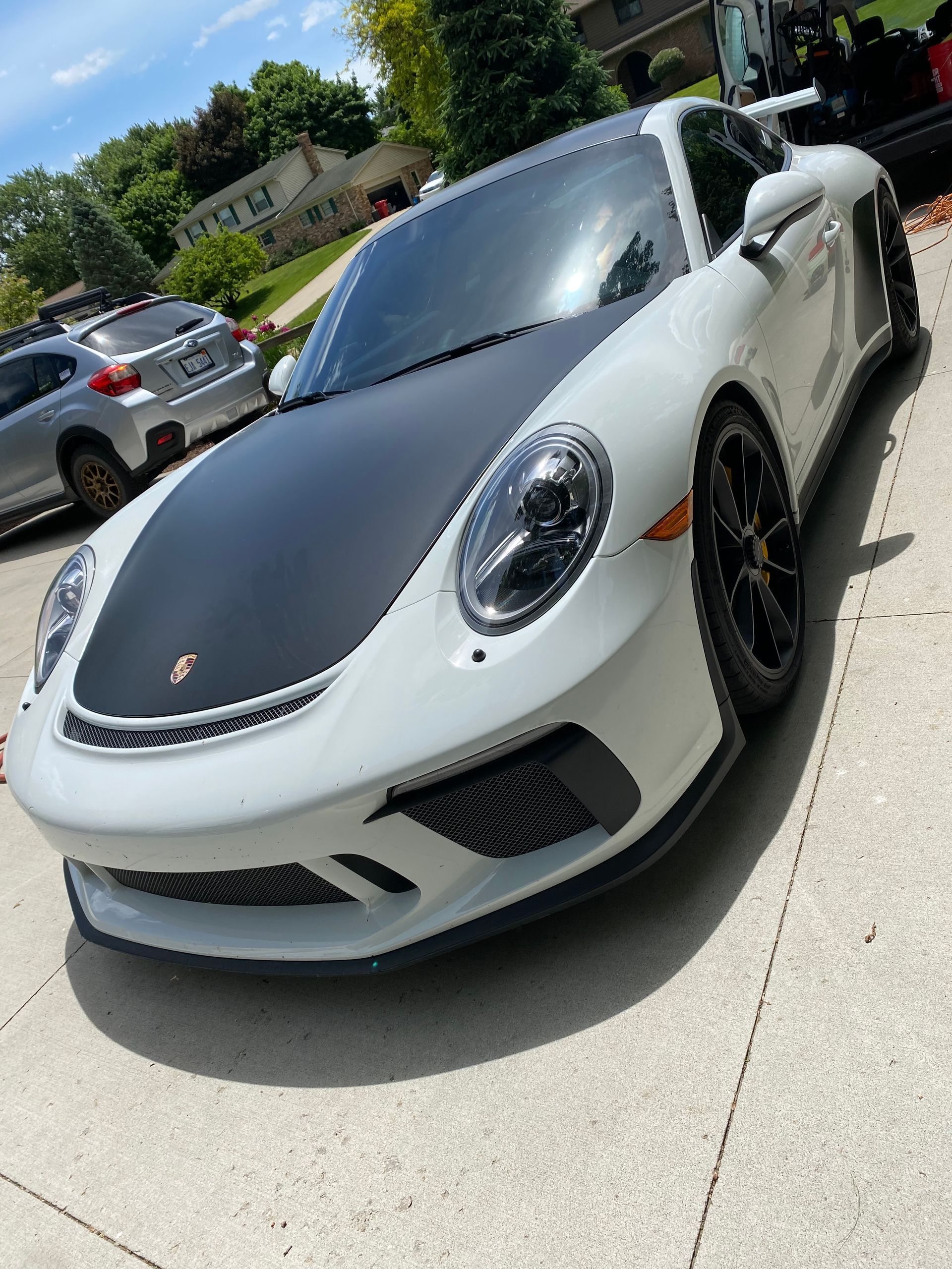 A blue sports car is parked in a showroom.