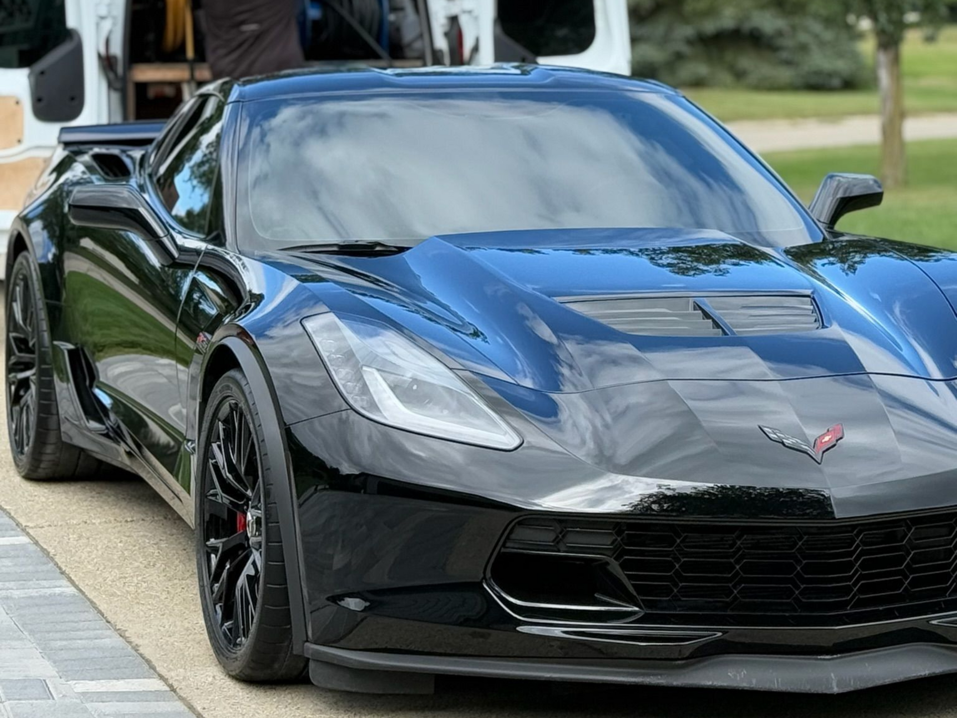 Black Corvette sports car parked outdoors.