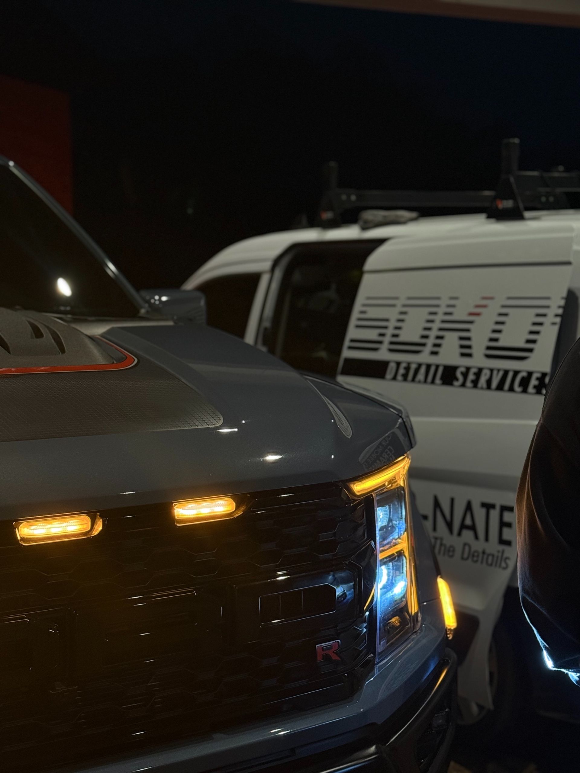 A blue sports car is parked in a showroom.