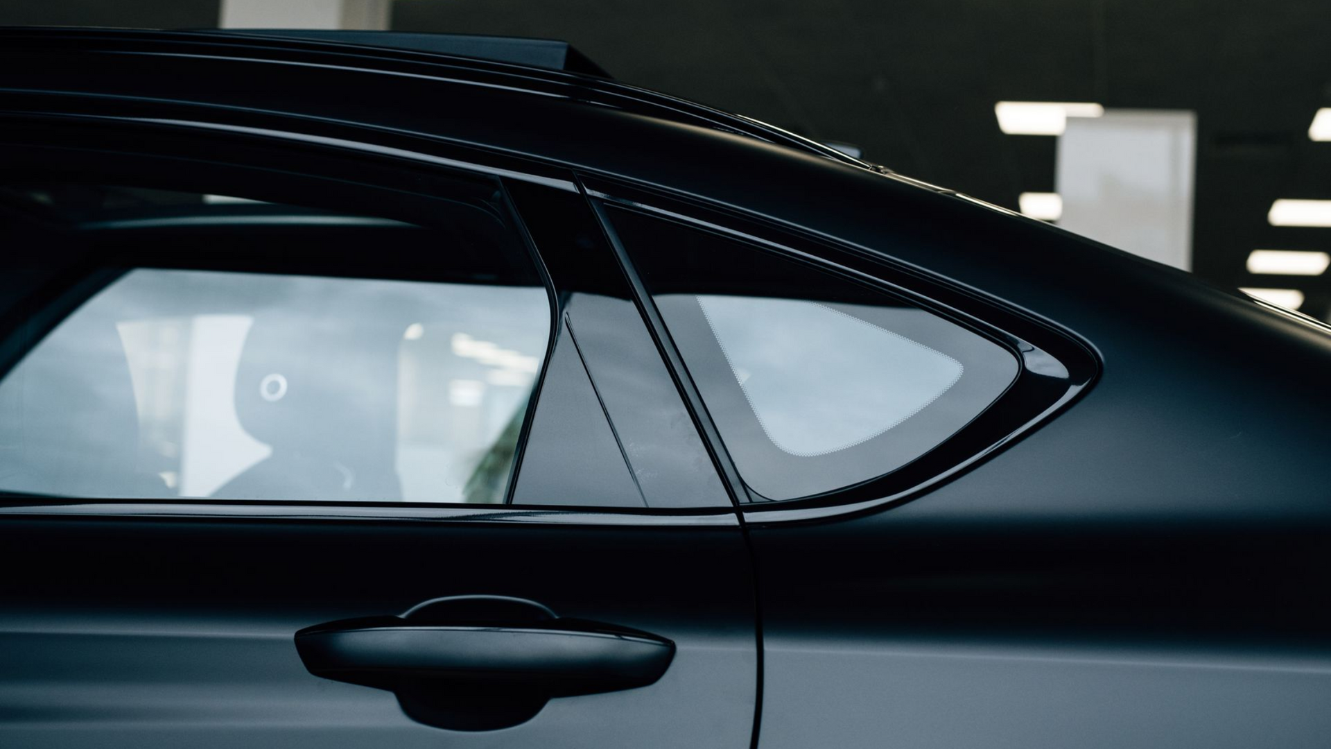 A close up of a car window with a sticker on it.