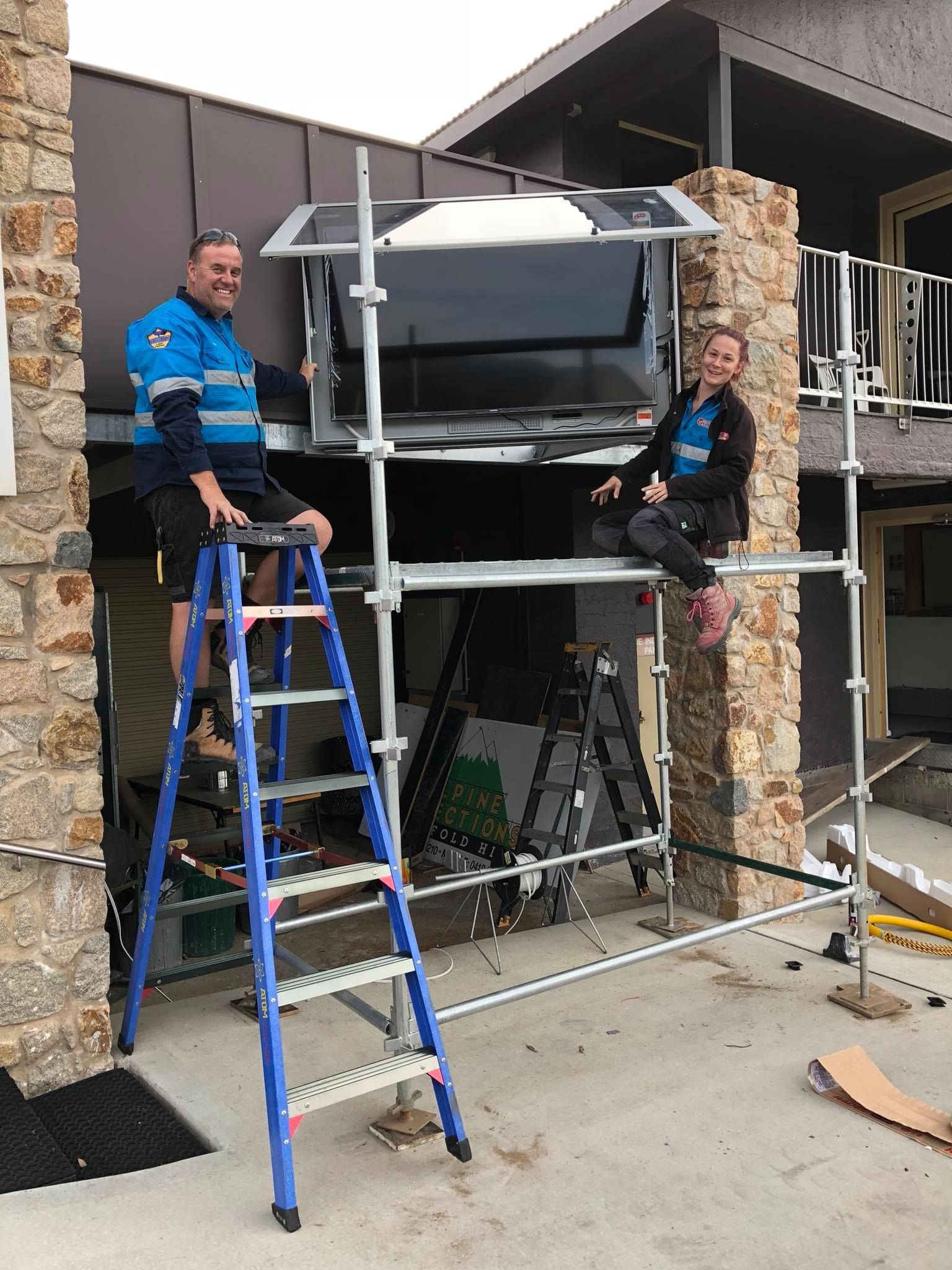 Technician With Screwdriver Repairing The Air Conditioner — John B Electrical In Albury NSW