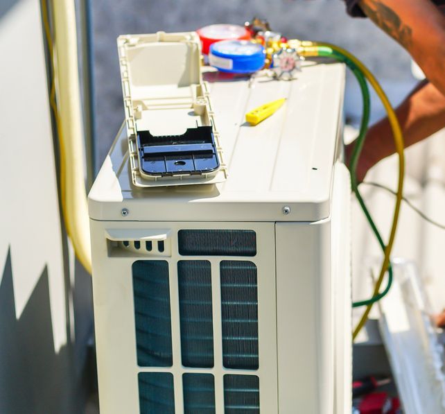 Air Conditioning Technician And Preparing To Install New Air Conditioner — John B Electrical In Yackandandah VIC