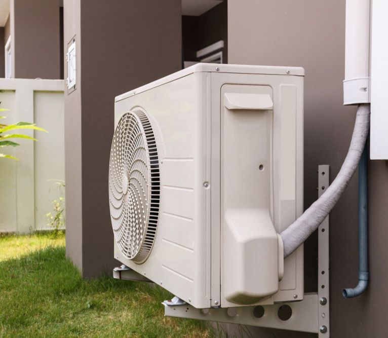 Air Conditioner Compressor Outdoor Unit Installed Outside The House — John B Electrical In Corowa NSW