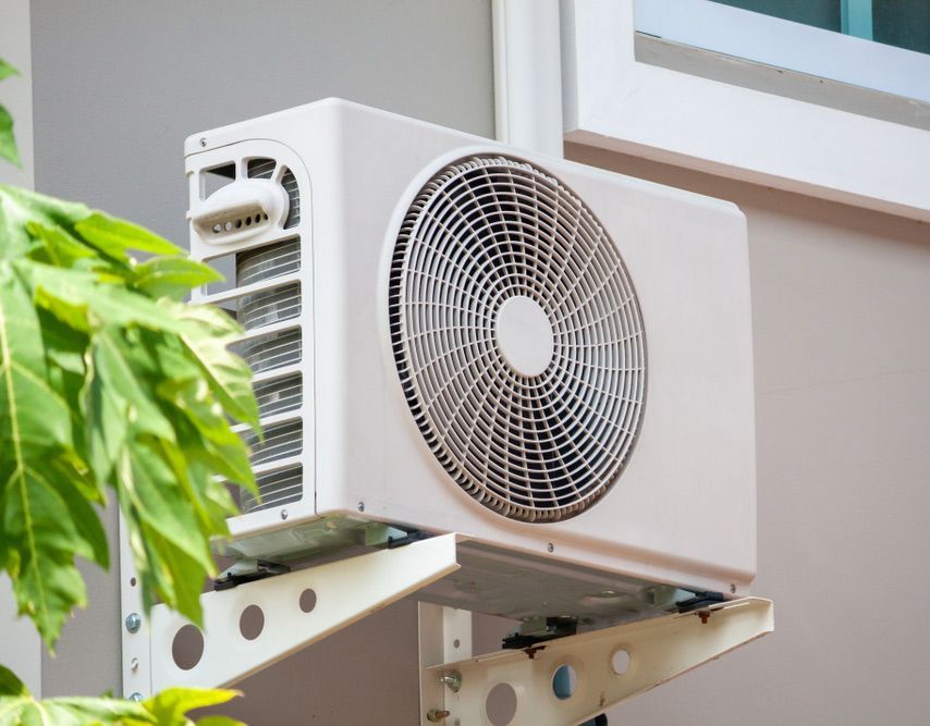 Air Conditioner Compressor Outdoor Unit Installed Outside The House — John B Electrical In Yackandandah VIC