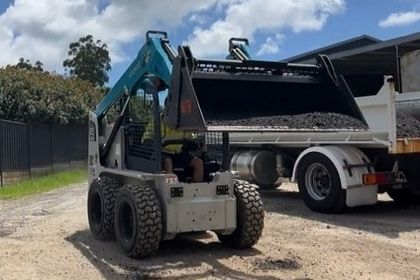 Skid steer bobcat loader moving gravel for a residential home owner in Wollongong nsw