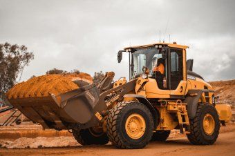 An earthmoving contractor working on transferring soil from excavation in Wollongong NSW.