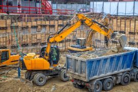 Excavator loading soil to a truck from a commercial excavation project in Wollongong NSW.