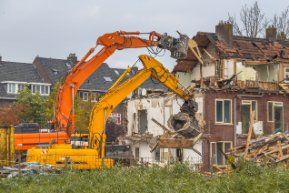 Two demolition cranes at work in a residential demolition project in Wollongong NSW.