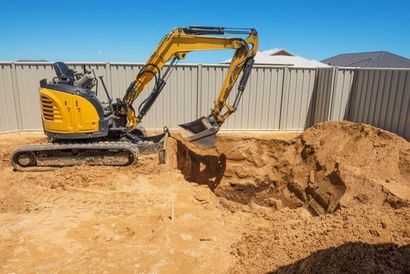 Mini excavator performing excavation for a swimming pool construction in Wollongong NSW home backyard