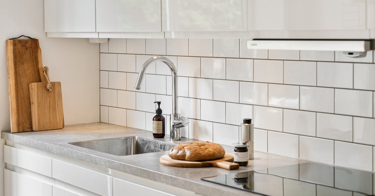 A kitchen with a sink , stove , and bread on the counter by D&D Construction Nottingham, Derby