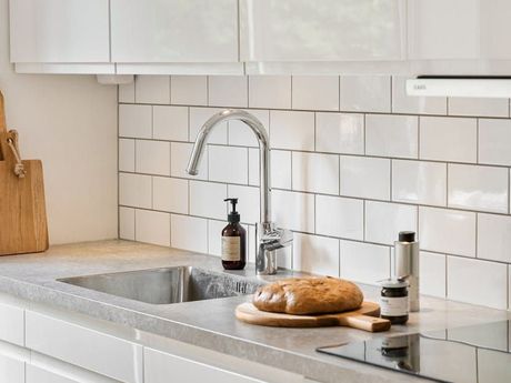 There is a loaf of bread on a cutting board in the kitchen. D&D Construction Nottingham