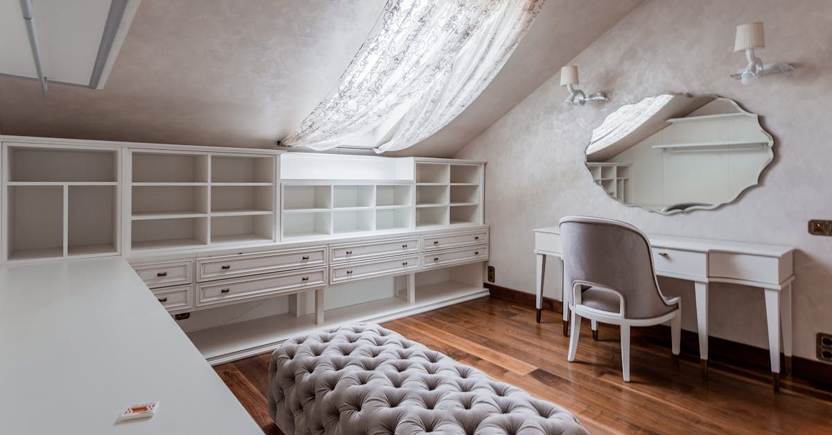 An extension room with a desk , chair , mirror and shelves by D&D Construction Nottingham