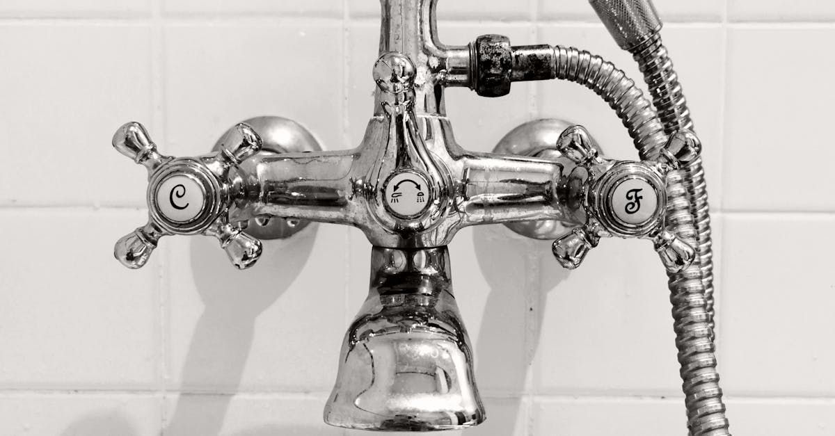 A close up of a bathroom faucet with a shower head attached to it. D&D Construction Nottingham