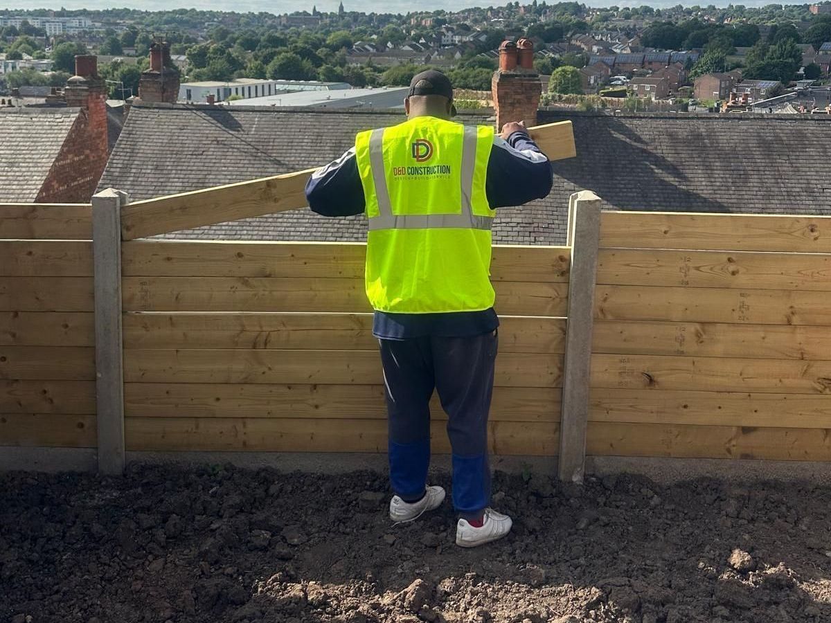 A man wearing a yellow safety vest with the letter d on it D&D Construction Nottingham