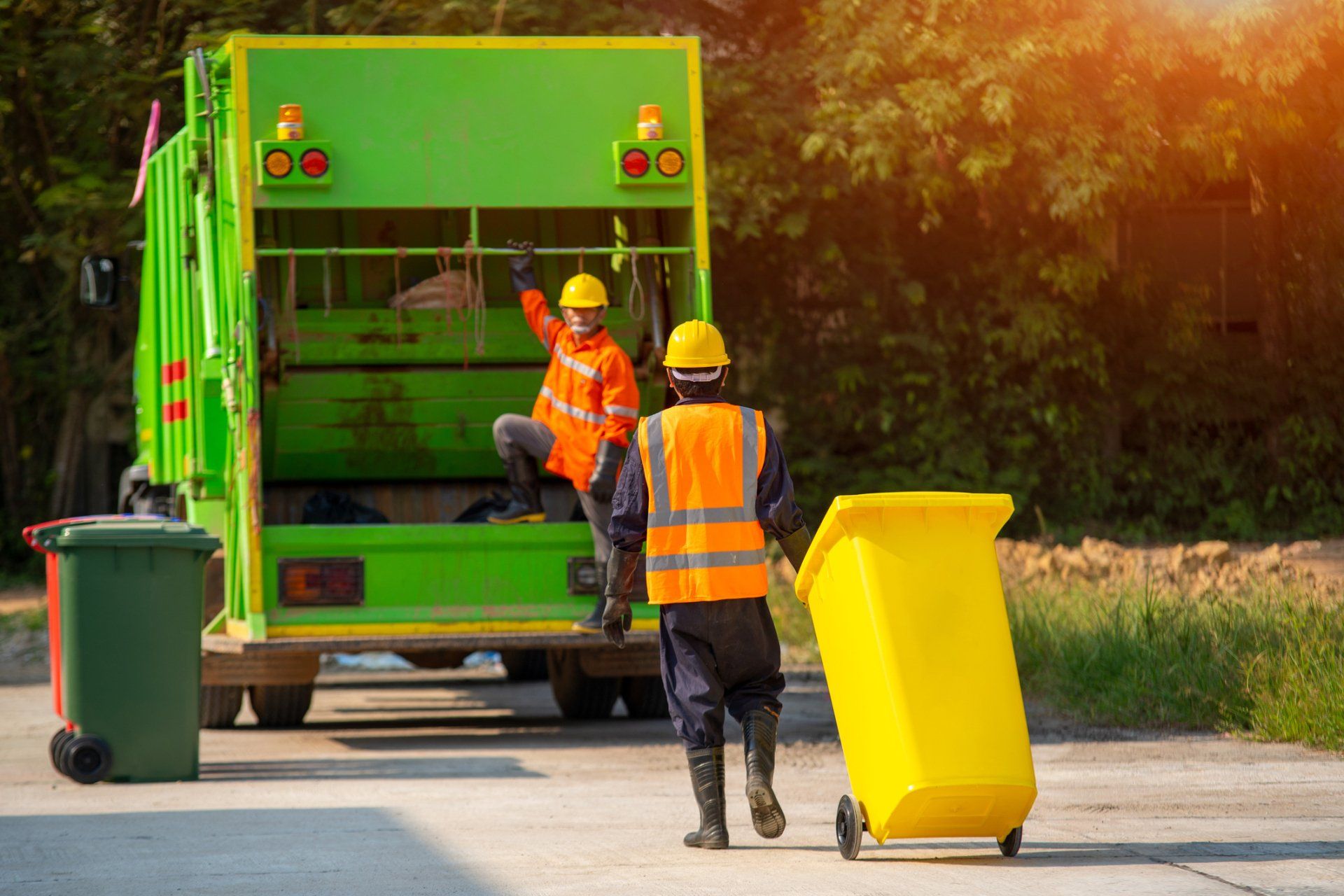Two Garbage Men Working Together - Chesapeake, VA - Western Branch Lawn & Landscapes