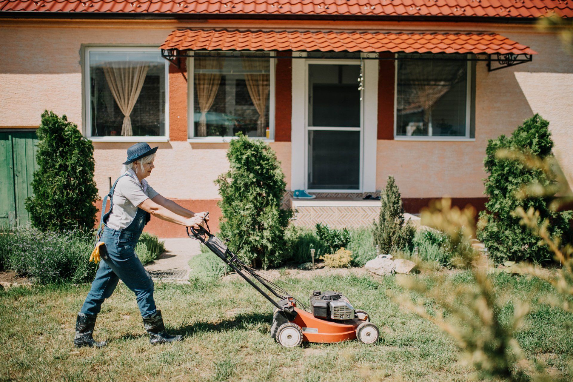 Woman Cuts The Lawn With Electric Mower - Chesapeake, VA - Western Branch Lawn & Landscapes