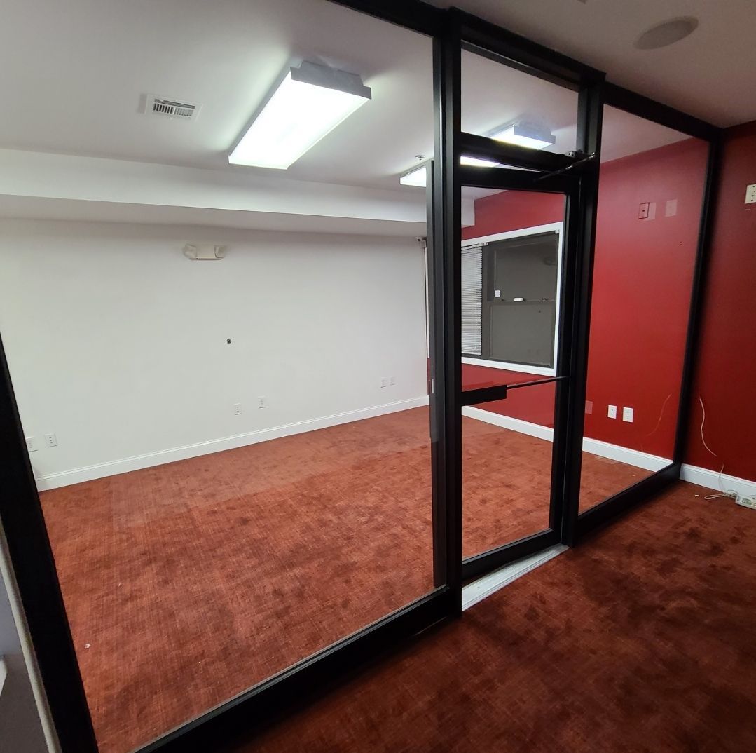 An empty room with red walls and a red carpet