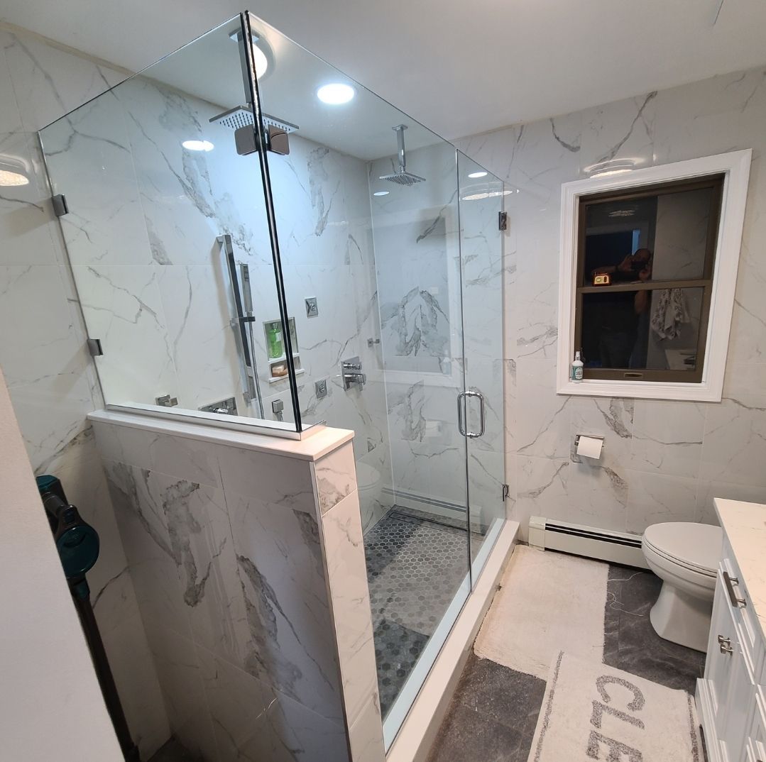 A bathroom with a walk in shower and a toilet.