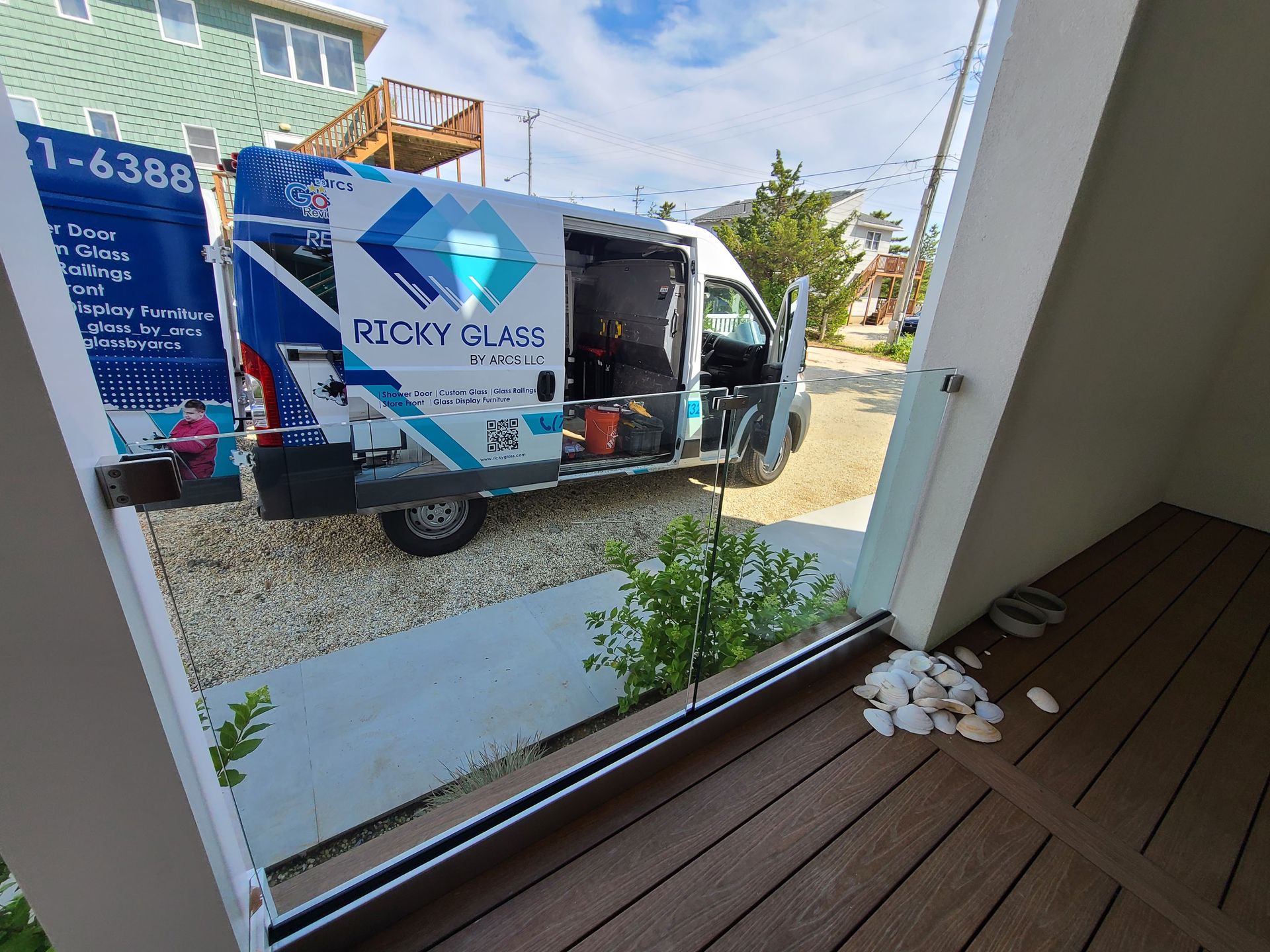 A white van is parked in front of a building.