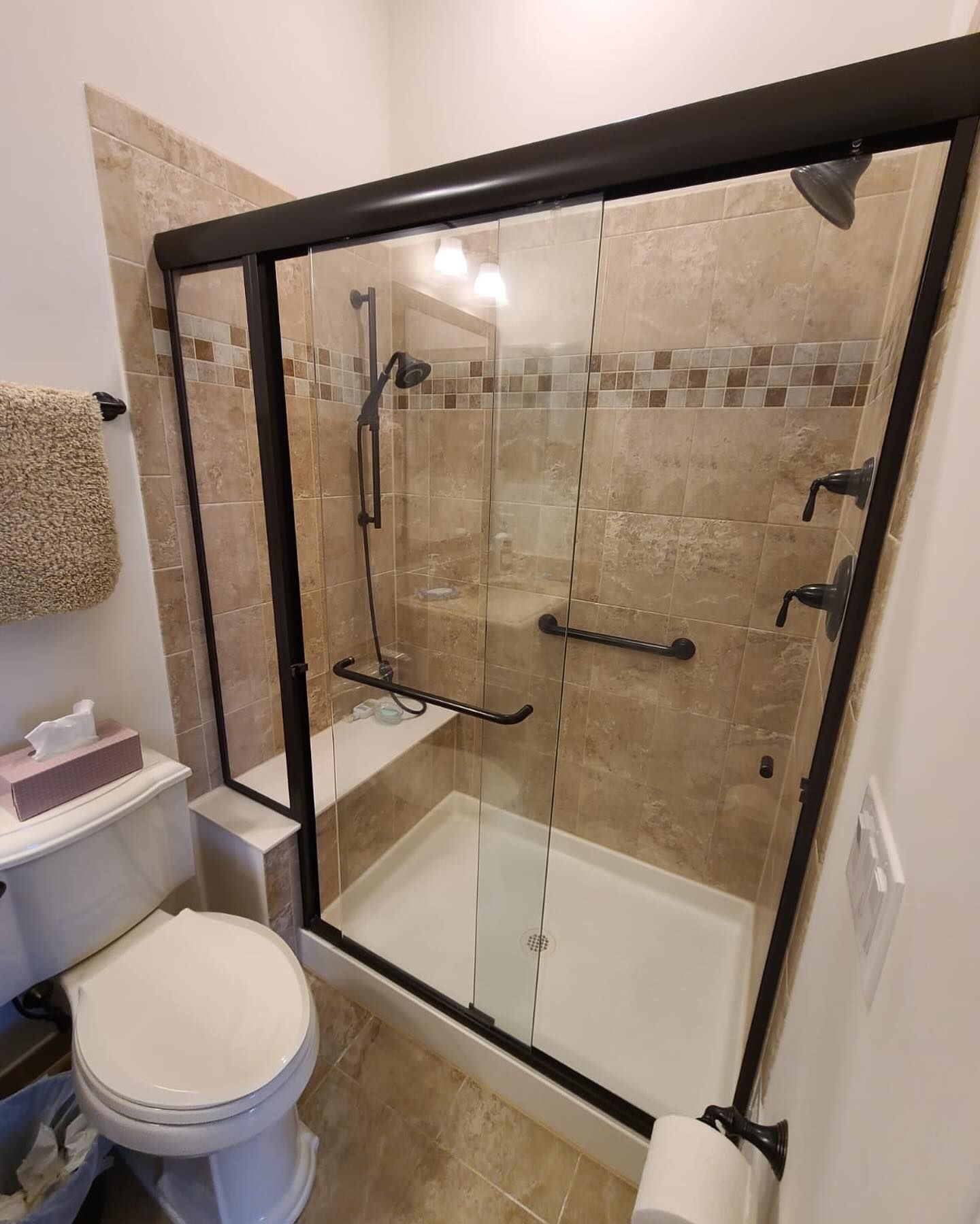 A glass door with a handle is open in a hallway.