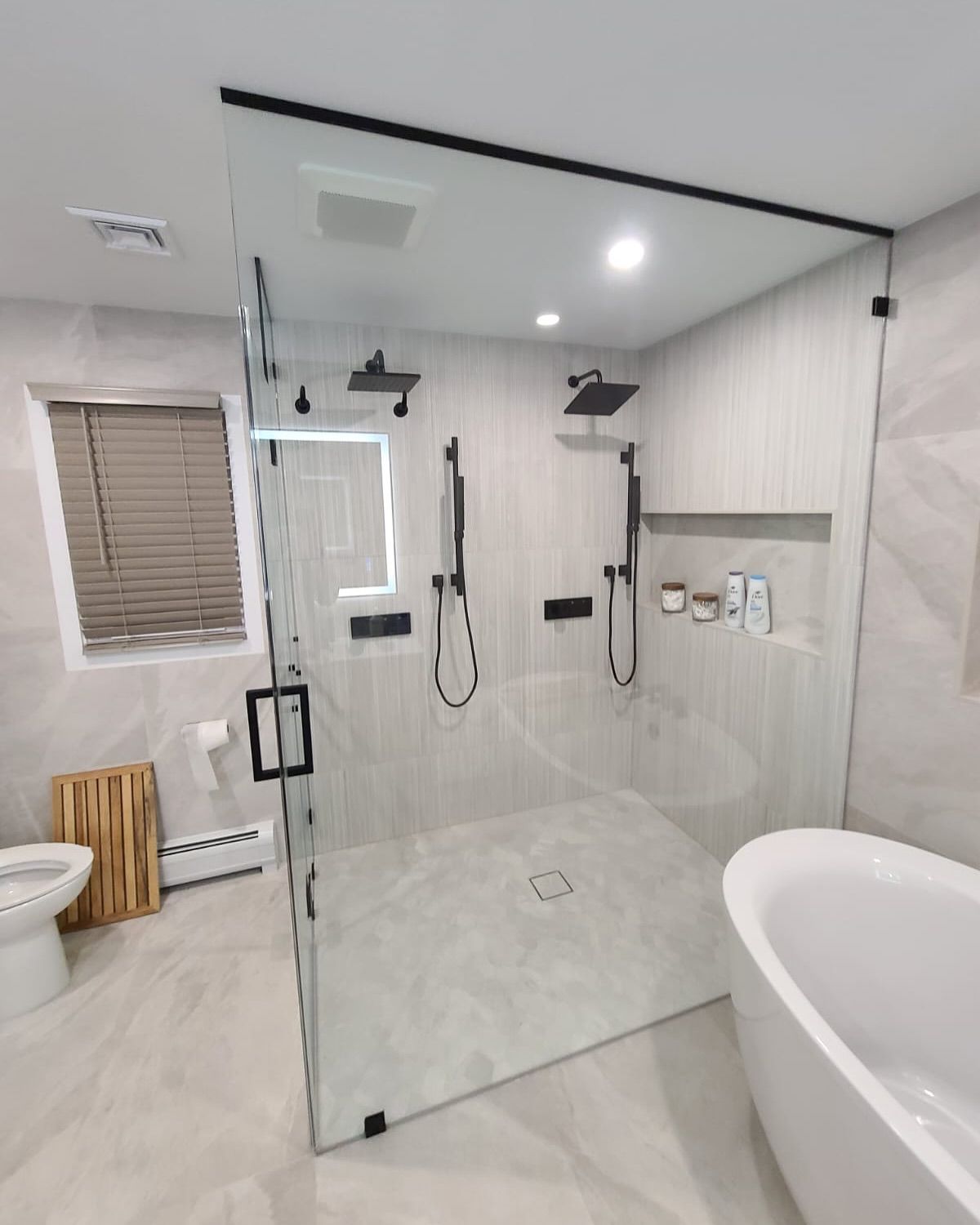 A bathroom with a walk in shower and a bathtub